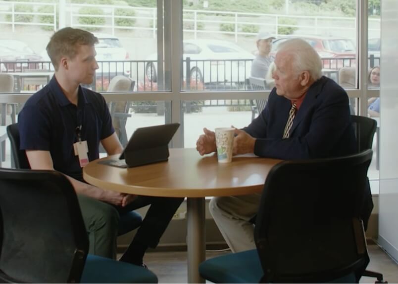 Dr. Hornsby sitting at a table with a student over coffee