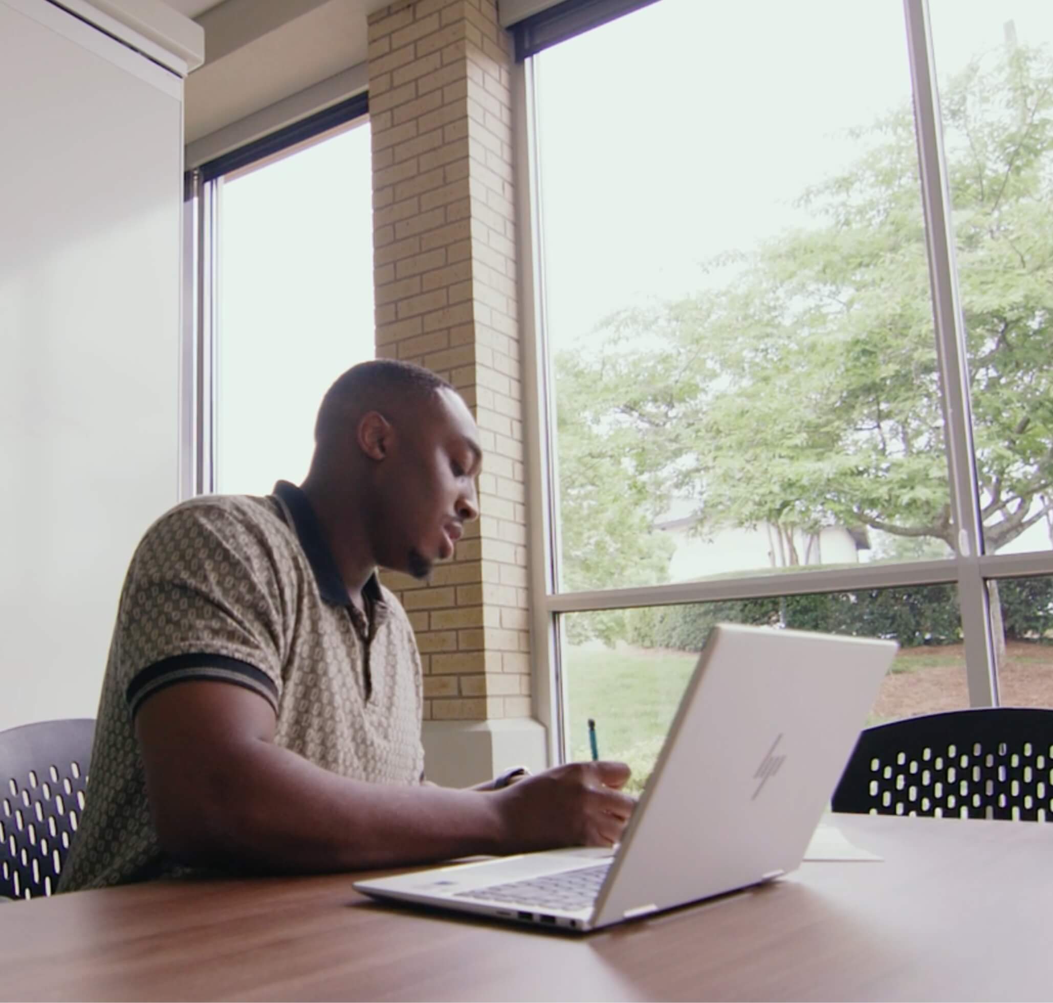 CRnA student writing and studying with his laptop open