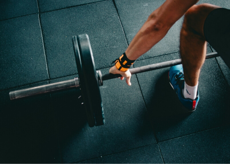 Male bending down to lift weights