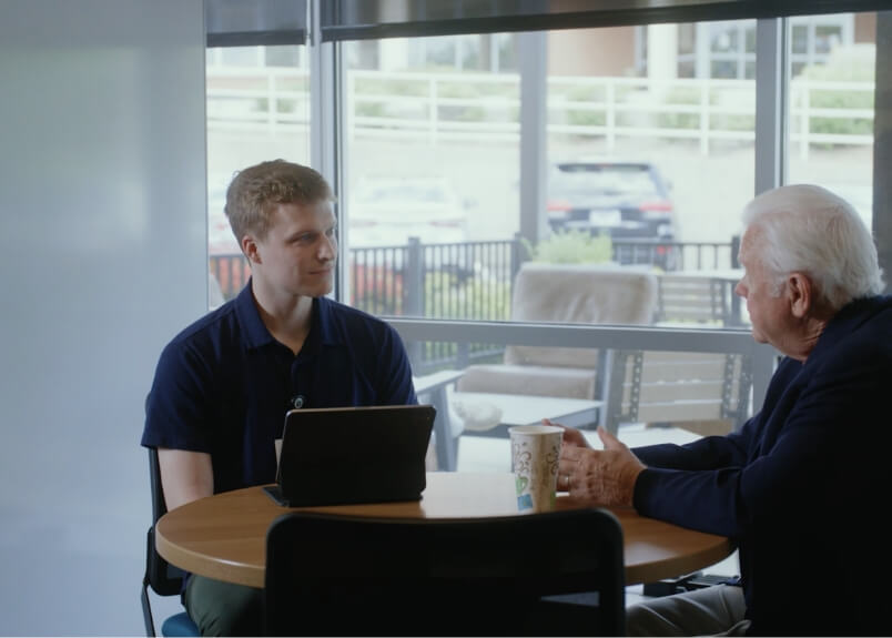 Student sitting for coffee with Larry Hornsby