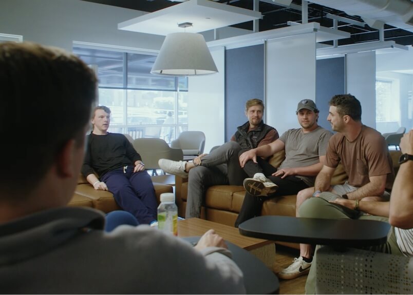 Students sitting inside on modern furniture talking