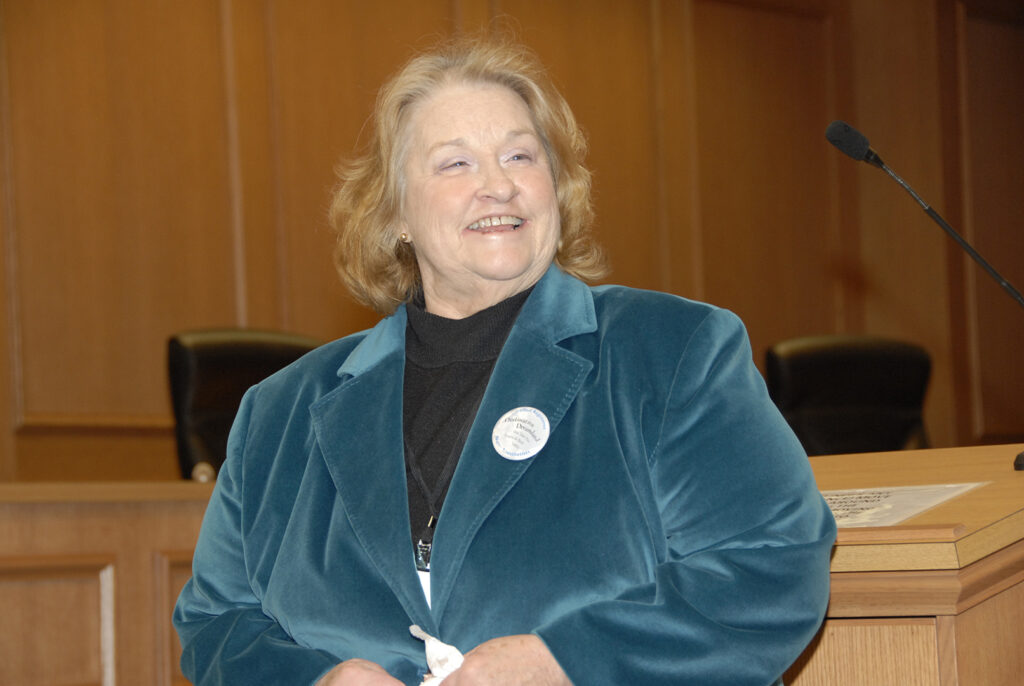 Patty Cornwell smiling at a podium