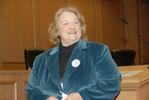 Patty Cornwell smiling at a podium