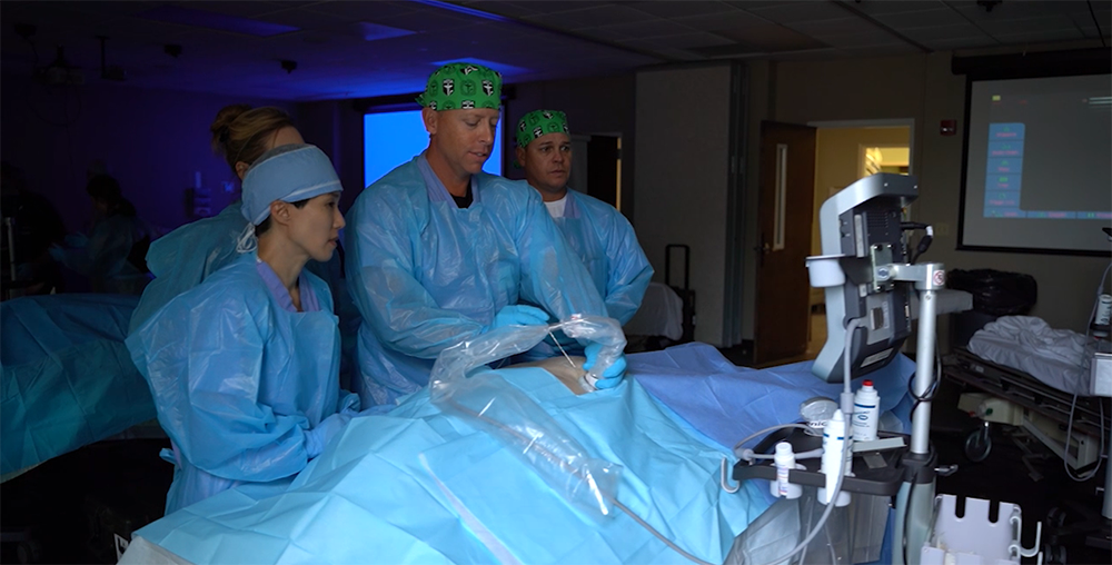 Four CRNA Students placing needle in cadaver