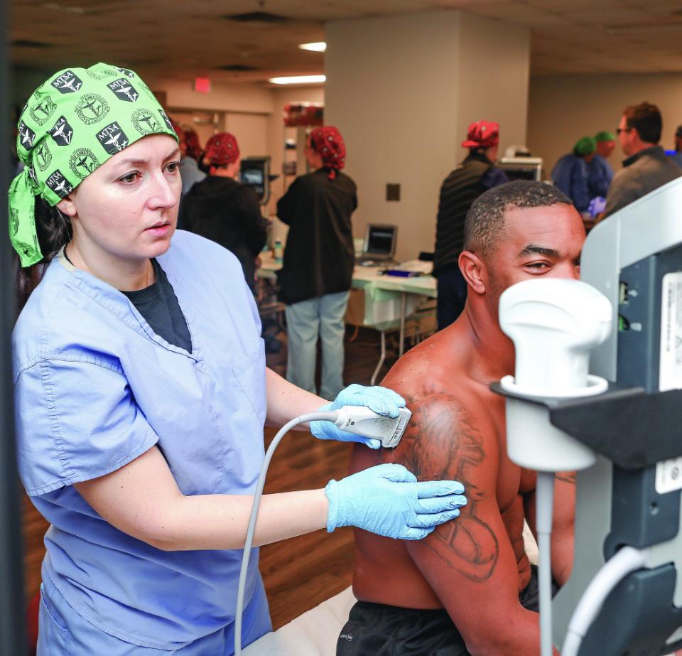 CRTNA student applying ultrasound techniques on patient's shoulder