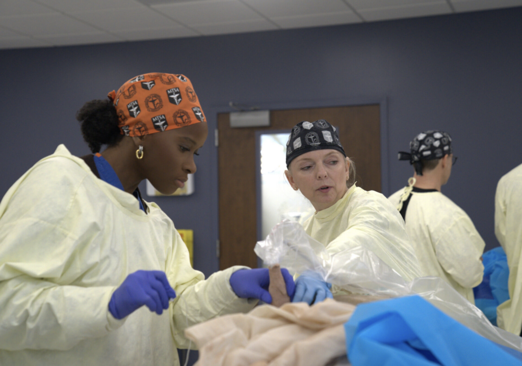 instructor working with student during a upm workshop